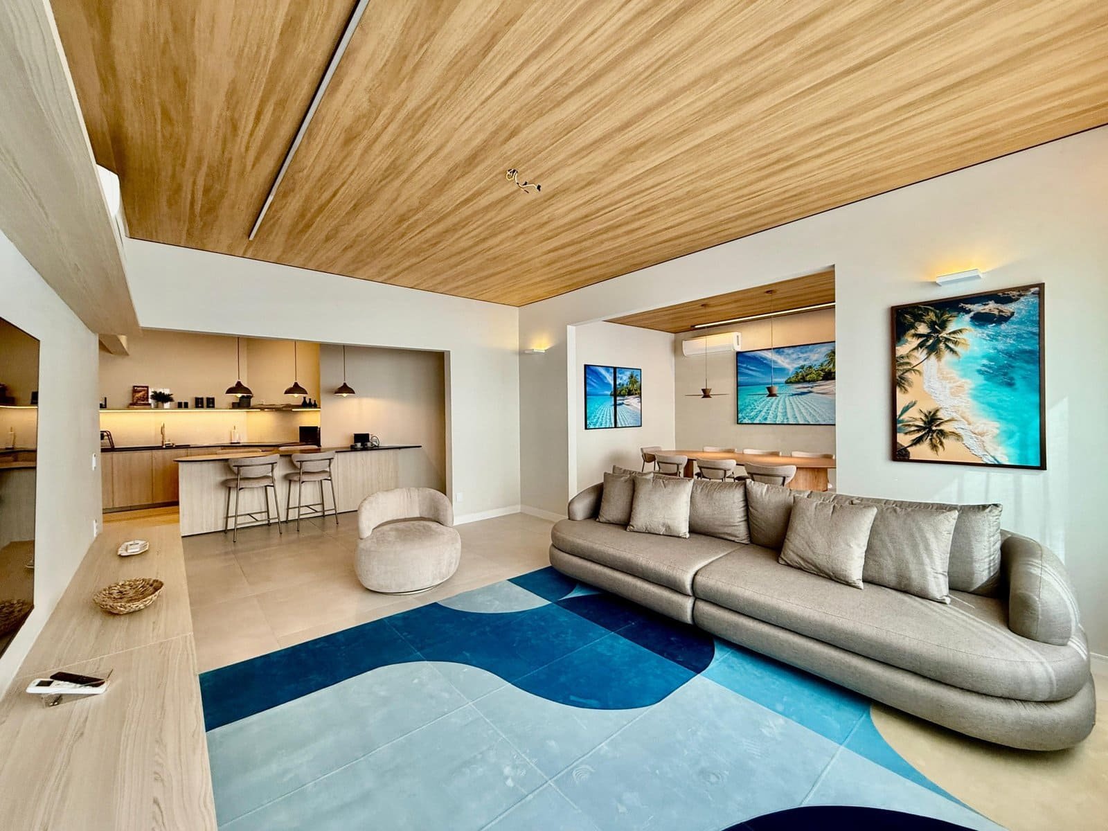 Luxo apartamento de lazer com decoração moderna, confortável sofá, televisão de tela plana, espaço de convivência com ambiente aberto e detalhes contemporâneos, decoração de interiores com presença de obras de arte na parede.